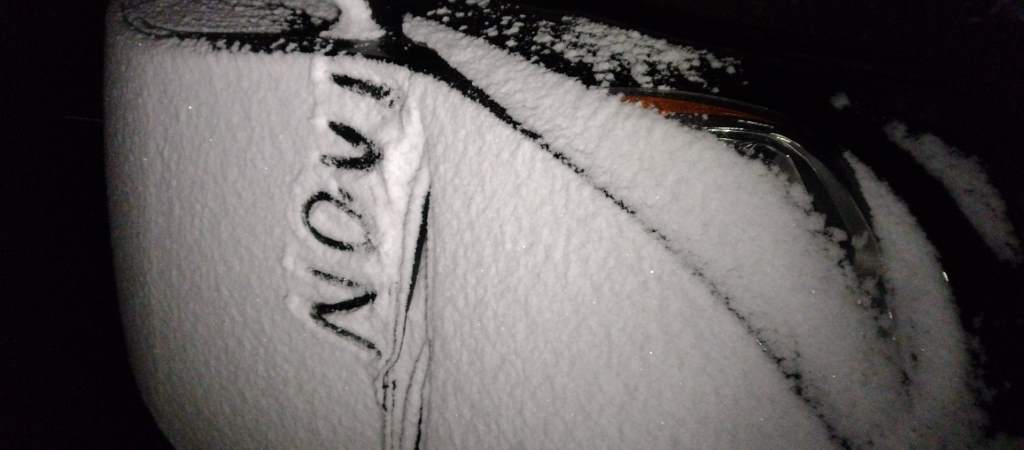Car windscreen with "Nov 1" drawn in snow.