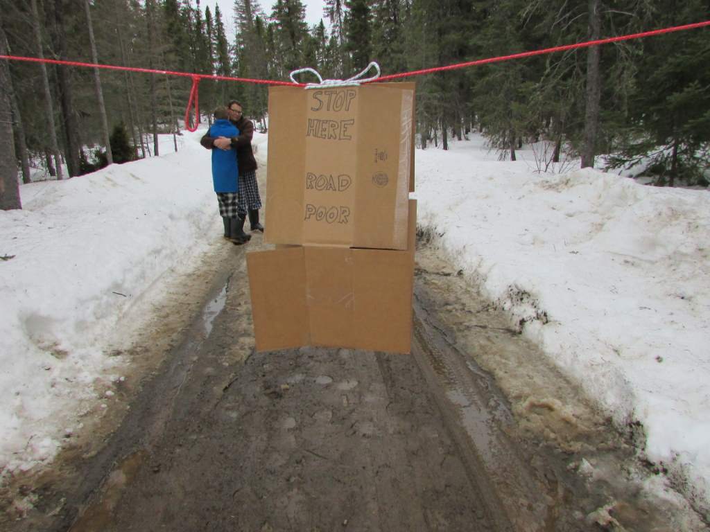 Cardboard sign closing a driveway.