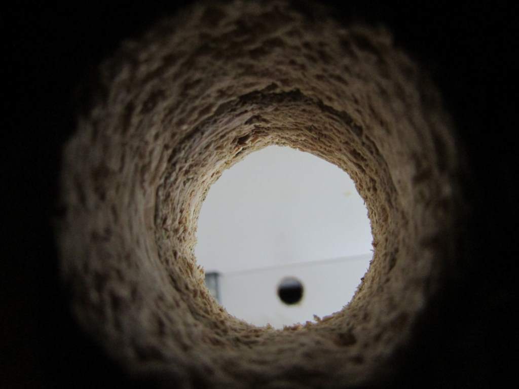 A view through a hole, of another hole.